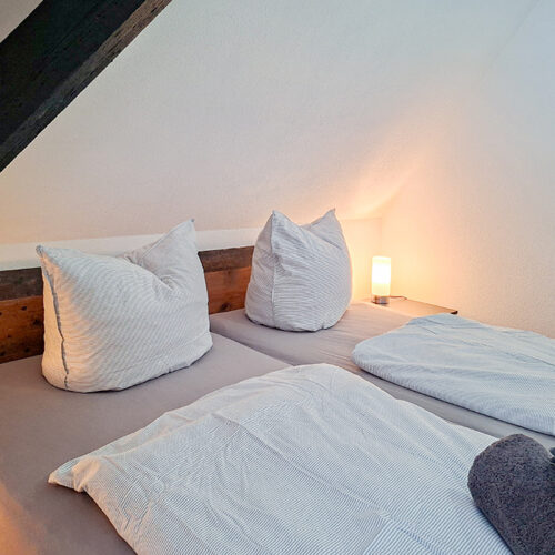 Schlafzimmer mit Doppelbett und Einzelbett - Wohnung 6
